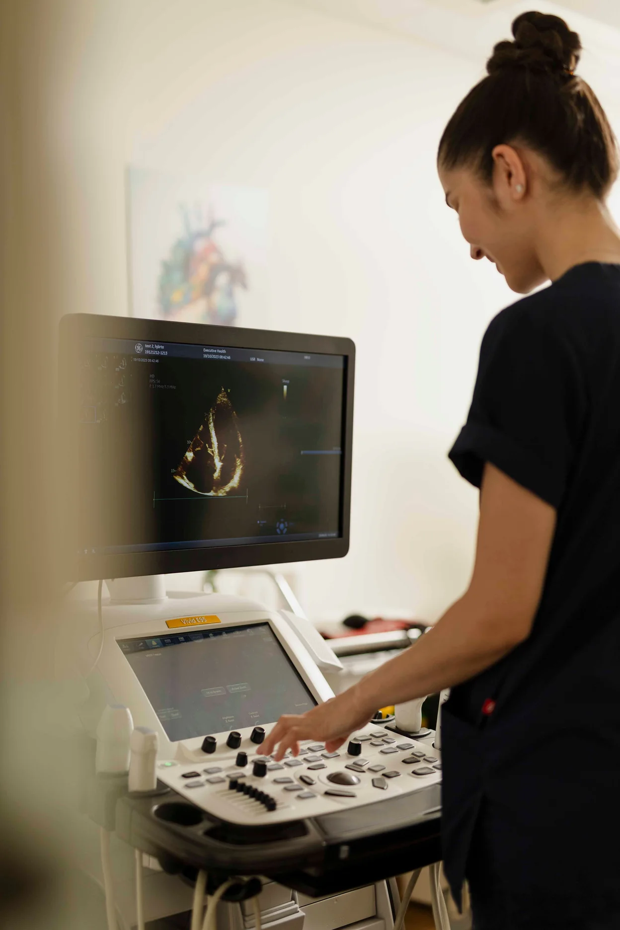 Echocardiography screening at Executive Health, sonographer at the ultrasound console.